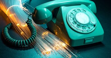 Vintage rotary telephone with glowing fiber optic cables representing modern VoIP and Asterisk telephony
